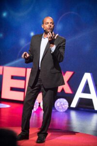 Thomas Anglero Delivering A Keynote To A Leadership Audience